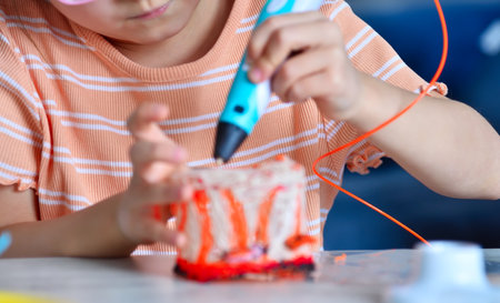 Little girl diligently making invention with 3D pen. Creativity and innovation in art concept.の写真素材