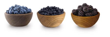 Black-blue berries isolated on white background. Collage of berries. Blueberry, bilberry, blackberry. Collection of fruits and berries in a bowl.の写真素材