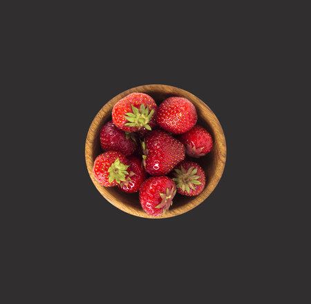 bowl with strawberries isolated on black background. Ripe strawberries close-up. Background berry. Sweet and juicy berry with copy space for text. Top view.の写真素材