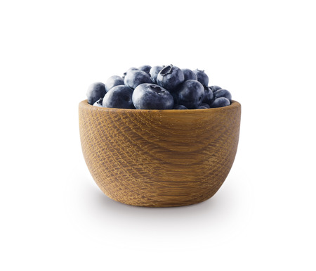 Blueberries in a wooden bowl isolated on white. Ripe blueberry with copy space for text. Blueberry on a white background.の写真素材