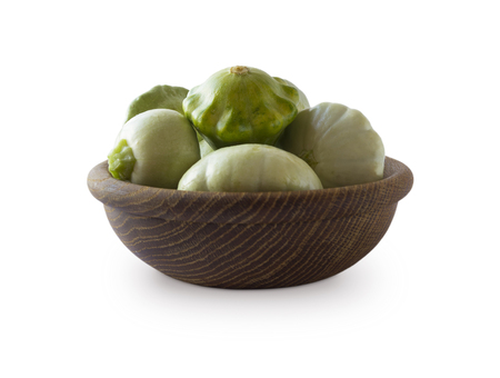 Squash in wooden bowl. Top view. Vegetables isolated on a white background. Vegetables with copy space for text.の写真素材