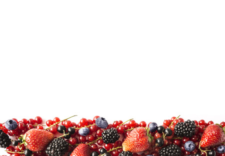 Mix berries on a white background. Ripe red currants, strawberries, blackberries, blueberries, blackcurrants on white background. Top view. Fruits with copy space for text. Black-blue and red food.の写真素材