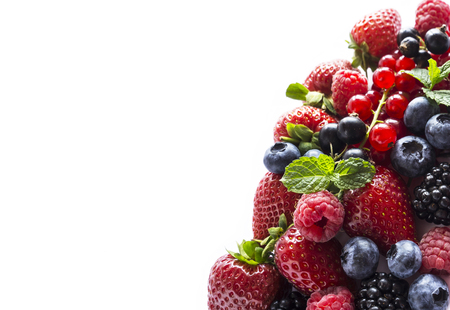 Fruits and berries isolated on white background. Ripe currants, raspberries, blueberries,  strawberries and blackberries with a mint leaf. Sweet and juicy fruits with copy space for text. Various fresh summer. Background of mix fruits on a white background. Top view.の写真素材