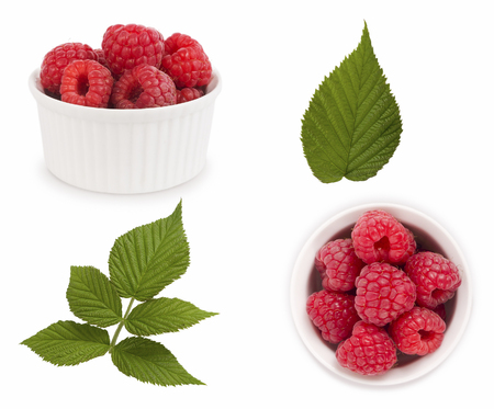 Set of red raspberries with leaves. Raspberries in a bowl isolated on white background. Vegetarian or healthy eating. Juicy and delicious raspberry with copy space for text.の写真素材
