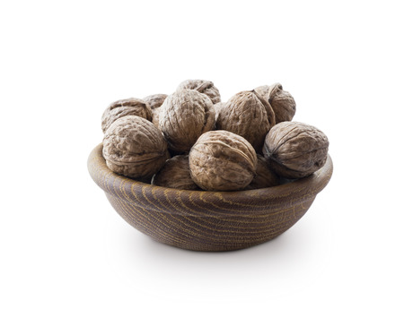 Walnuts isolated on white background. Heap of walnuts isolated on white background. Walnut in a wooden bowl on white background. Walnuts with copy space for text.の写真素材