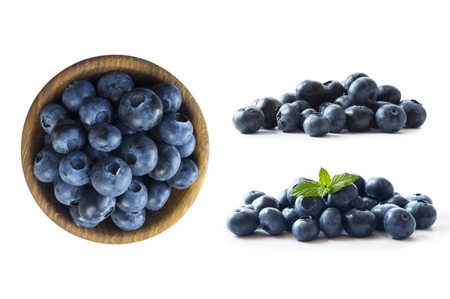 Blueberries in a wooden bowl. Ripe blueberries with copy space for text. Blueberry isolated on white. Bilberries  on a white background. Top view. Blueberries on a white background. Various fresh summer berries. Blue food.の写真素材