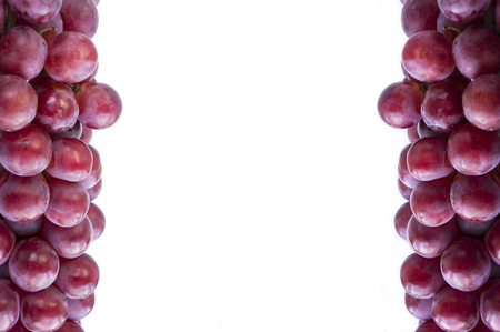 Red grapes on white background. Top view.  Bunch of grape on white background.  Pink bunch grape on white.の写真素材