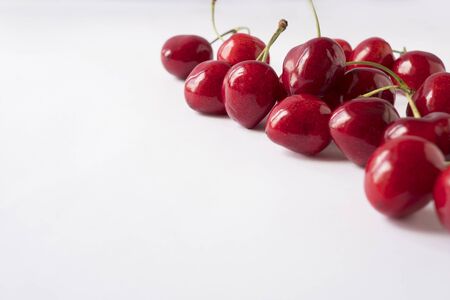 Cherries on a white background. Fresh red cherries. Texture blueberry berries close up. Cherry...