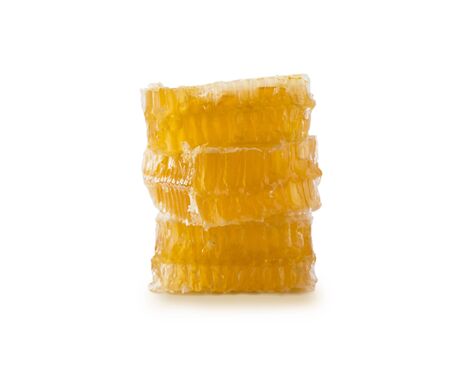 Honeycomb piece. Honey slice isolated on white background. Yellow Honeycomb slice closeup isolated on white.  Honey cell slice isolated on white background. Package design element with clipping path.の写真素材