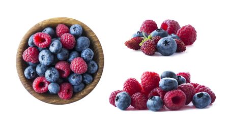 Ripe berries isolated on white background. Blueberries, wild strawberries and raspberries. Mix berries and fruits with copy space for text. Mix berries on white background. Pink and blue food. Berries from different angles on white.の写真素材