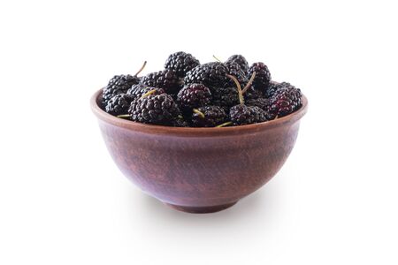 Mulberries in bowl isolated on white background. Black mulberry on white background. Ripe and tasty berry with copy space for text. Sweet and juicy mulberry isolated on white background.の写真素材