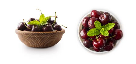 Red cherries in bowl isolated on white background. Ripe cherries and mint leaves close-up. Sweet and juicy berry with copy space for text.  Cherry from different angles on white background. Top view.の写真素材