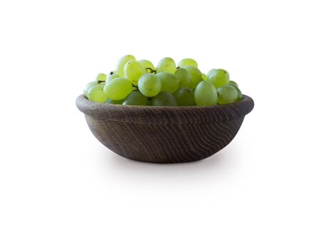 Green grapes Kishmish isolated on white background. Top view. Grapes in a wooden bowl isolated on white background. Vegetarian or healthy eating.Top view.Green grapes Kishmish with copy space for textの写真素材