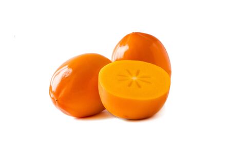 Persimmon with copy space for text. Orange ripe persimmon isolated on white background. Three persimmon on white. Persimmon fruit isolated on white background. Persimmon slice cut out.の写真素材