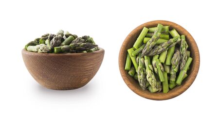Bowl of asparagus isolated on white background. Asparagus with copy space for text on white.Edible asparagus sprouts isolated on white background.Set of edible asparagus from different angles.Top viewの写真素材