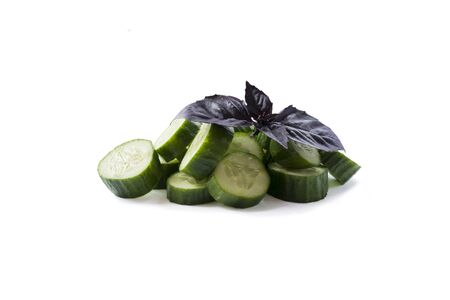 Sliced cucumber isolated on white. Cucumbers with copy space for text. Cucumbers with oregano leaf isolated on white. Fresh cucumber slices isolated on white background. Ð¡hopped cucumber vegetables.の写真素材