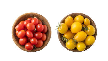 Red and yellow tomatoes lay on white background. Top view. Cherry tomatoes on a wooden bowl isolation. Tomatoes isolated on a white background. Copy space. Set of tomatoes of different varieties.の写真素材