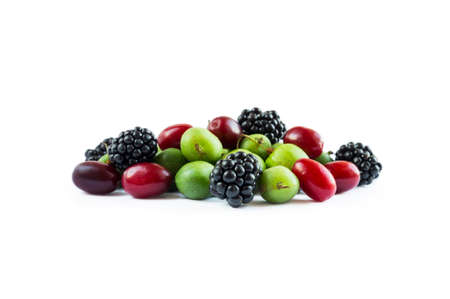 Mix berries isolated on white background. Actinidia and blackberry with copy space for text. Berry isolation. Mixed berries isolated on white. Heap of berries on white background.の写真素材