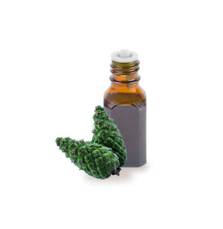 A bottle with fir tree essential oil. Essential oil fir tree isolated on white background. Essential oil aromatherapy, spruce cone. Aromatherapy, perfumery, cosmetics.の写真素材