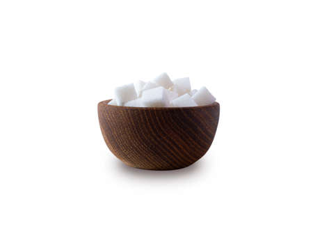 Sugar cube isolated on white. Selective focus. Sugar cube in wooden bowl on white background. Heap of sugar with copy space for text.の写真素材