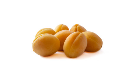 Heap of apricots isolated on white background. Ripe apricots with copy space for text. Apricots isolated on white background. Fruit on white background. Various fresh summer fruits.の写真素材