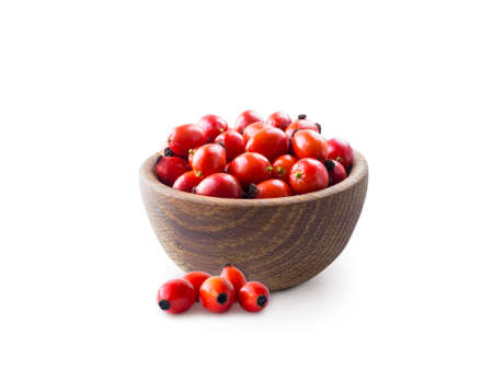 Fresh rosehip berries on white background. Top view. Rosehip berries in a bowl isolated on white background. Rose hip berries with copy space for text.の写真素材