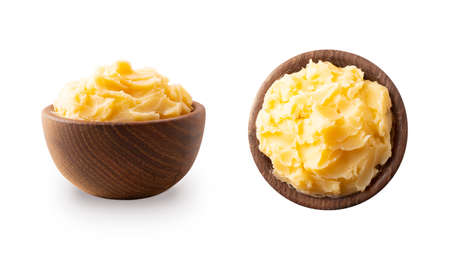 Ghee or clarified butter in wooden bowl, cooking oil, pure ghee isolated on white background. Clarified butter with copy space for text on white. Ghee butter in a bowl from different angles.Top viewの写真素材