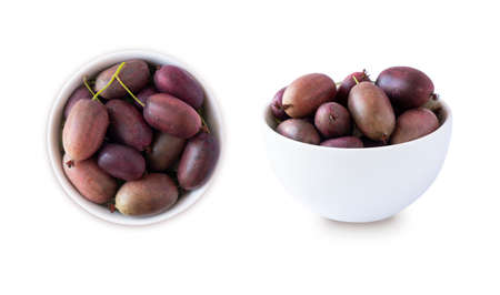 Actinidia isolated on white background. Actinidia in a bowl with copy space for text. Kiwi fruit actinidia. Baby kiwi fruits in a bowl from different angles.Top viewの写真素材