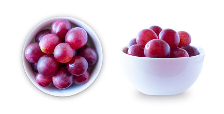 Grapes isolated on white background. Grapes in a bowl in frontal view and top view. Bunch of grape isolated on white background. Pink bunch grape isolated on white.の写真素材