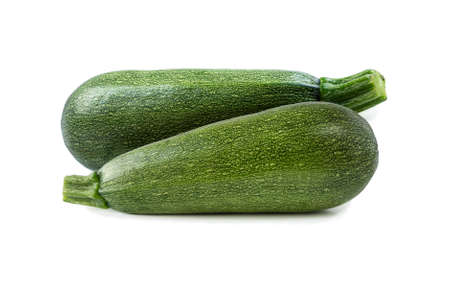 Fresh cut zucchini isolated on a white background. Design element for product label. Design image of fresh whole zucchini. Green zucchini vegetables isolated on white.の写真素材