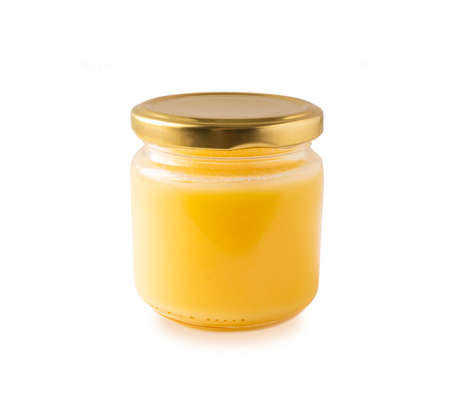Ghee or clarified butter in jar, cooking oil, pure ghee isolated on white background. Clarified butter with copy space for text on white.の写真素材
