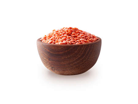 Red lentils in wooden bowl isolated on white background with clipping path. Bowl of red split lentil isolated on white backgroundの写真素材
