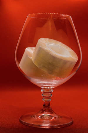 stationery tape in a glass goblet on an orange background. Abstract.の写真素材