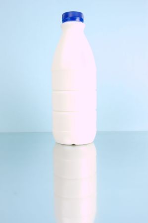 Full cream milk isolated against a blue backgroundの写真素材