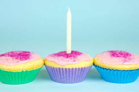 Cup cakes isolated against a blue backgroundの写真素材