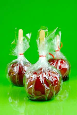 Candy apples isolated against a green backgroundの写真素材