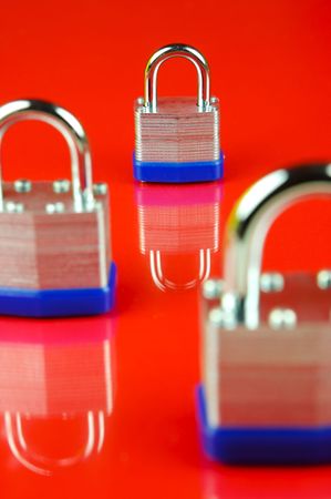 Padlocks isolated against a red backgroundの写真素材