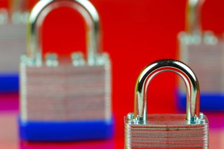 Padlocks isolated against a red backgroundの写真素材
