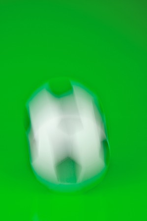 A soccor ball isolated against a green backgroundの写真素材