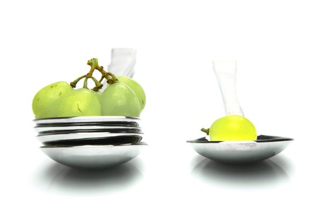 Grapes on a spoon isolated against a white backgroundの写真素材