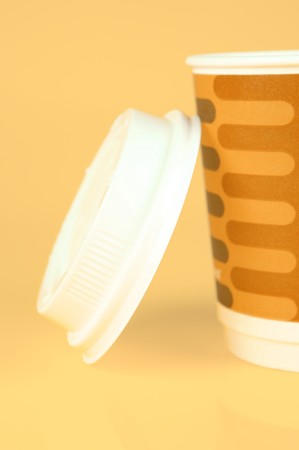 Takeaway coffee cups isolated against an orange background の写真素材