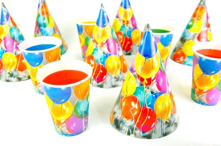 Party cups and hats isolated against a white backgroundの写真素材