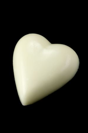 White chocolate love heart isolated against a black backgroundの写真素材