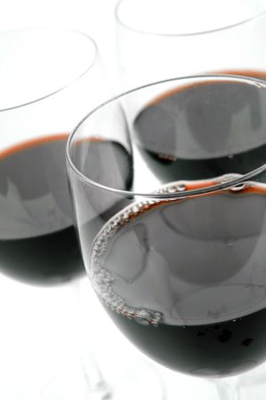 Glasses of red wine isolated against a white backgroundの写真素材