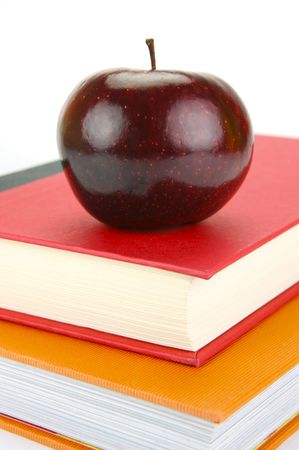 A red apple isolated on a white background with school booksの写真素材