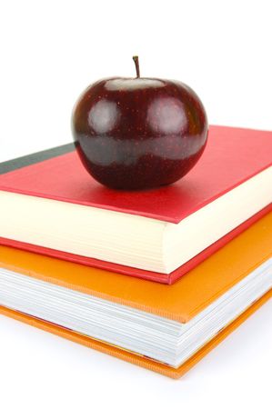 A red apple isolated on a white background with school booksの写真素材