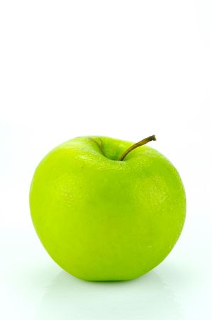 A rgreen apple isolated against a white backgroundの写真素材