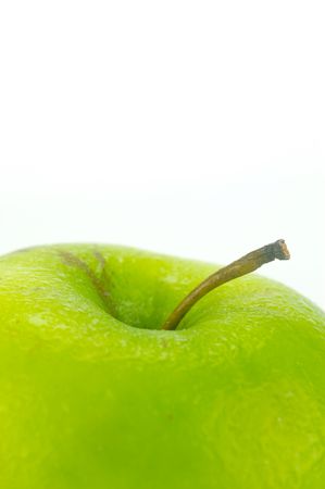 A rgreen apple isolated against a white backgroundの写真素材
