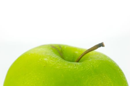 A rgreen apple isolated against a white backgroundの写真素材