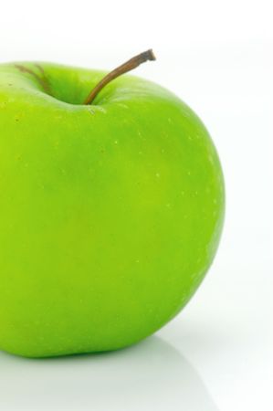 A rgreen apple isolated against a white backgroundの写真素材